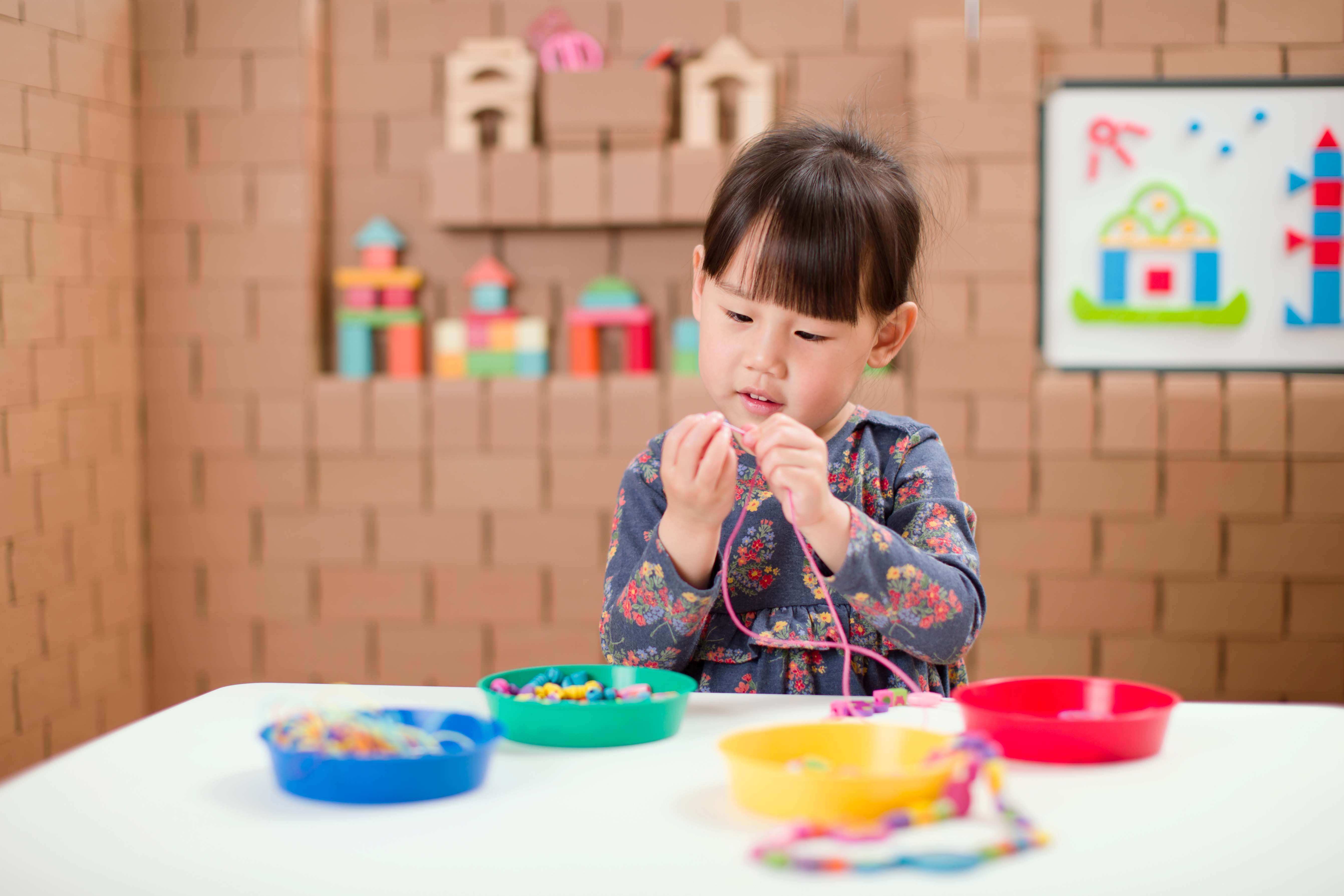child playing with beads